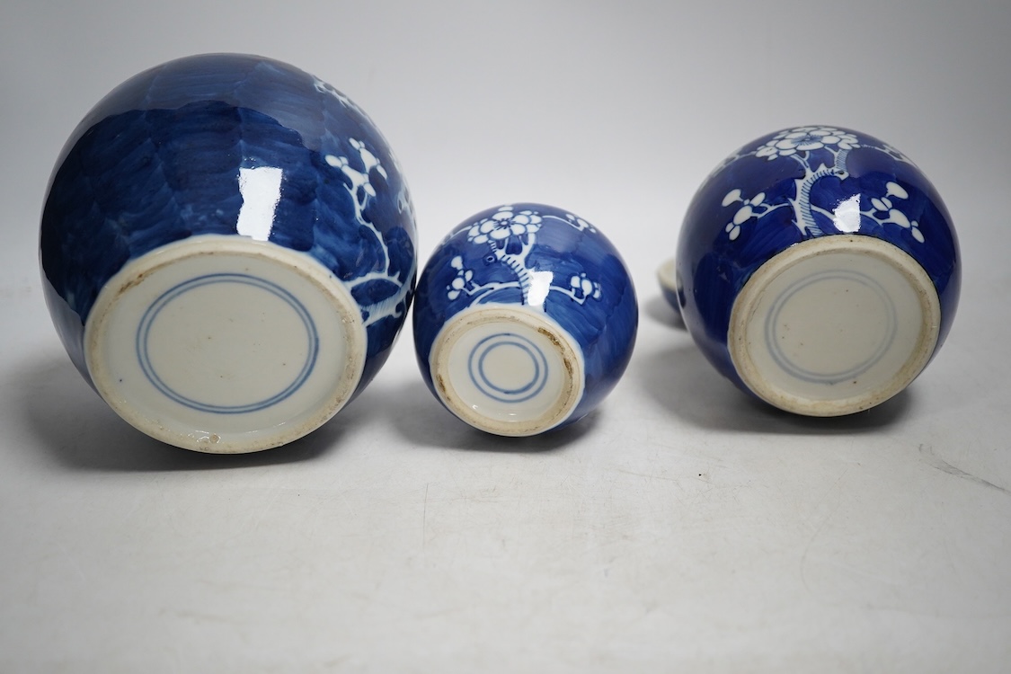 Three late 19th century Chinese blue and white prunus jars, tallest 15cm. Condition - one cover broken in two and re-glued, otherwise good